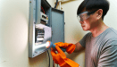 Person checking the circuit breaker in a home